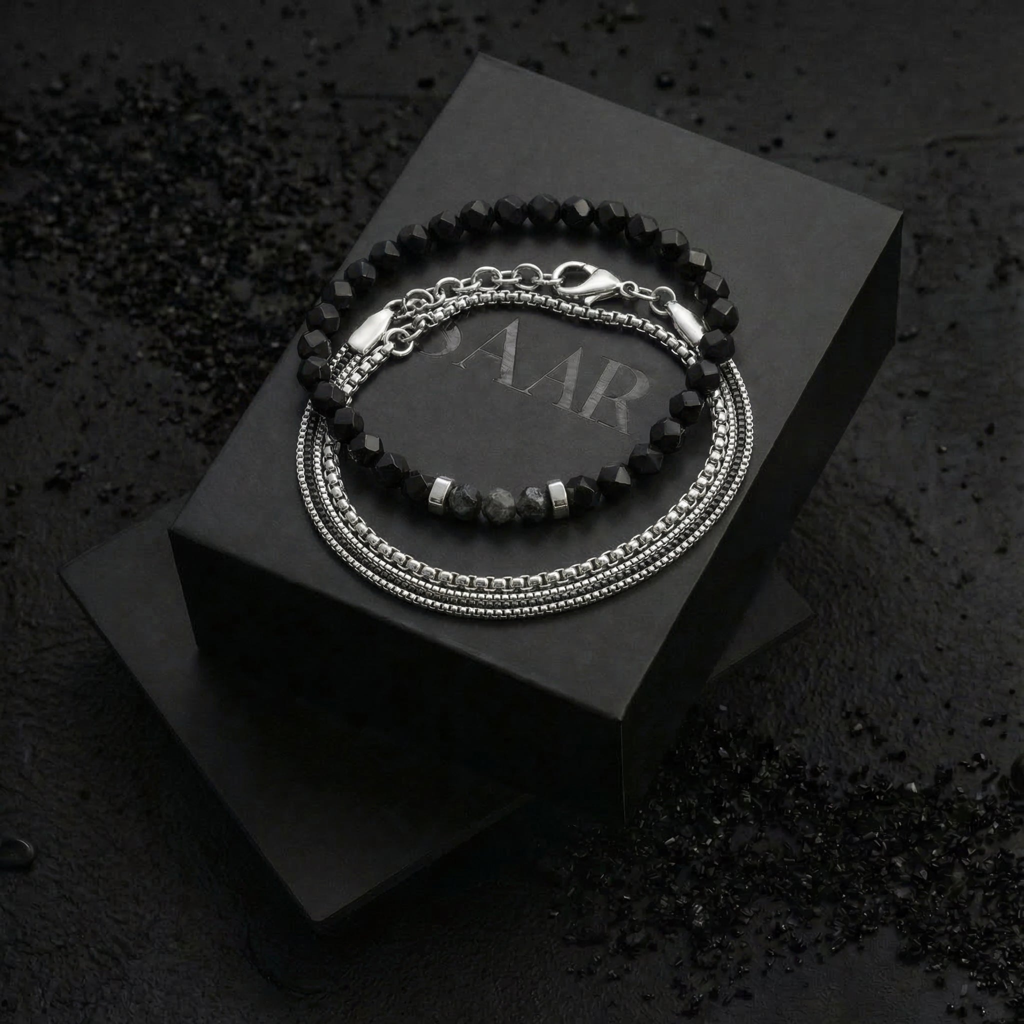 1 Stainless steel layered bracelet with a lobster clasp and 1 6mm diamond cut black Onyx gemstones elastic bracelet