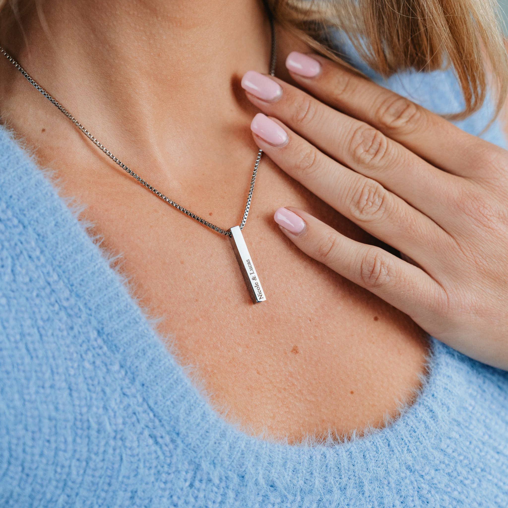 A female wearing SAAR CO's LAUREN, a Stainless Steel box pendant chain. The pendant has been engraved with Nicole & Lucas.