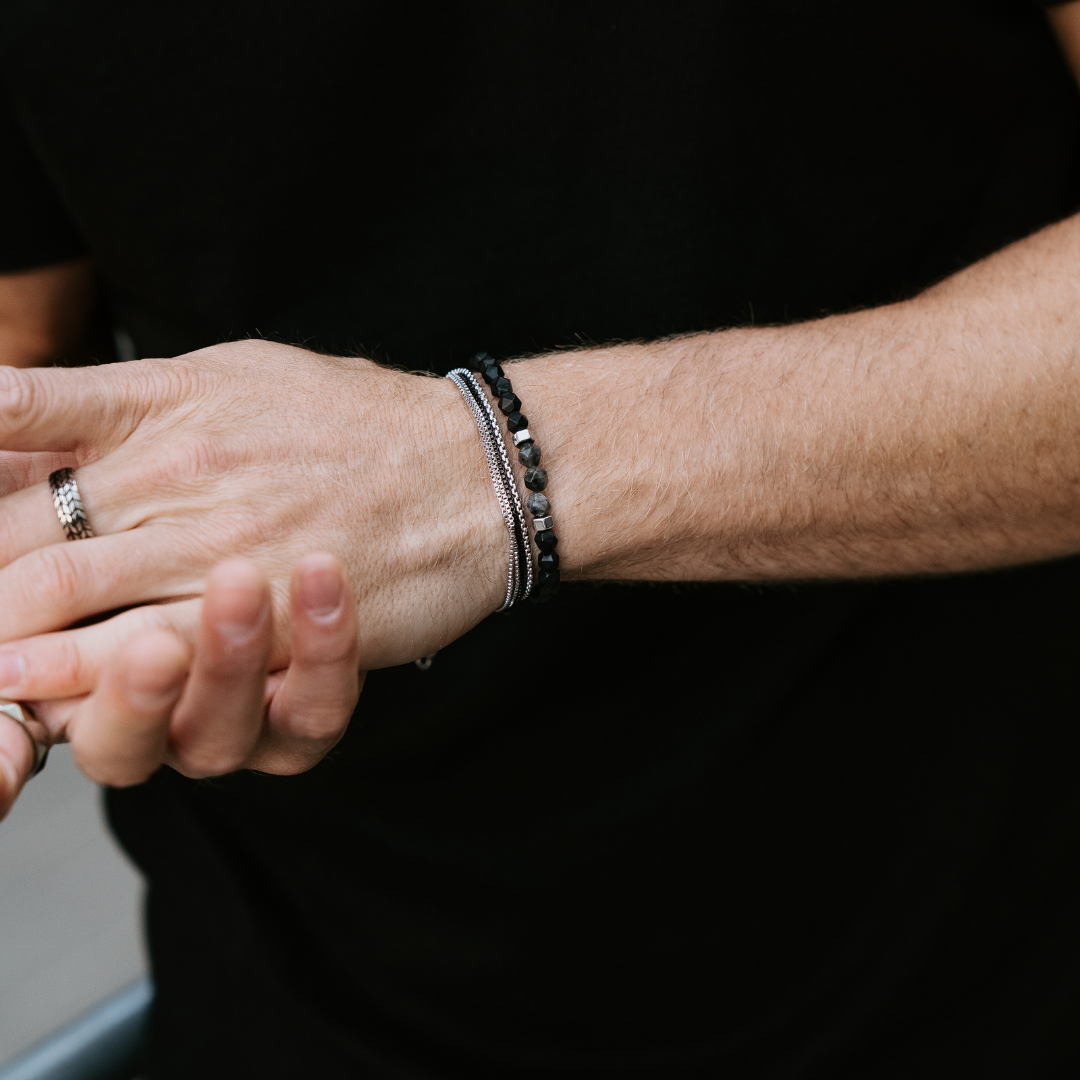 1 Stainless steel layered bracelet with a lobster clasp and 1 6mm diamond cut black Onyx gemstones elastic bracelet